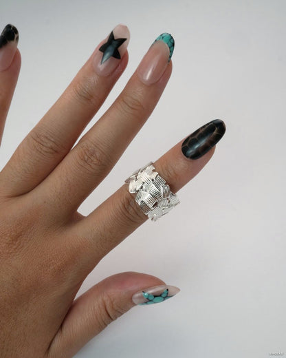 Weave Echo Ring worn on hand, bold silver woven band with polished texture