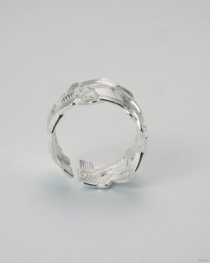 Weave Echo Ring worn on hand, bold silver woven band with polished texture